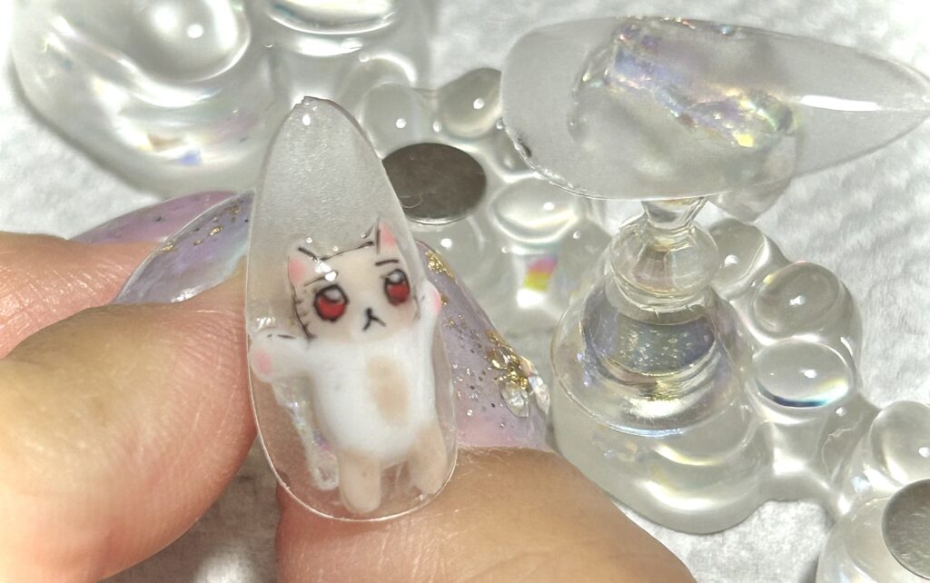 alt="しょがの全身をネイルパーツで作ったけど顔が上手にかけなかった"